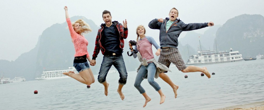 A group of smiling people jumping in happiness