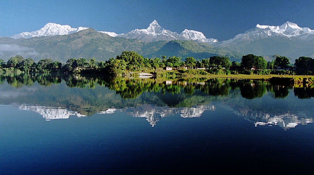 A lake and mountains topped with snow, pokhara