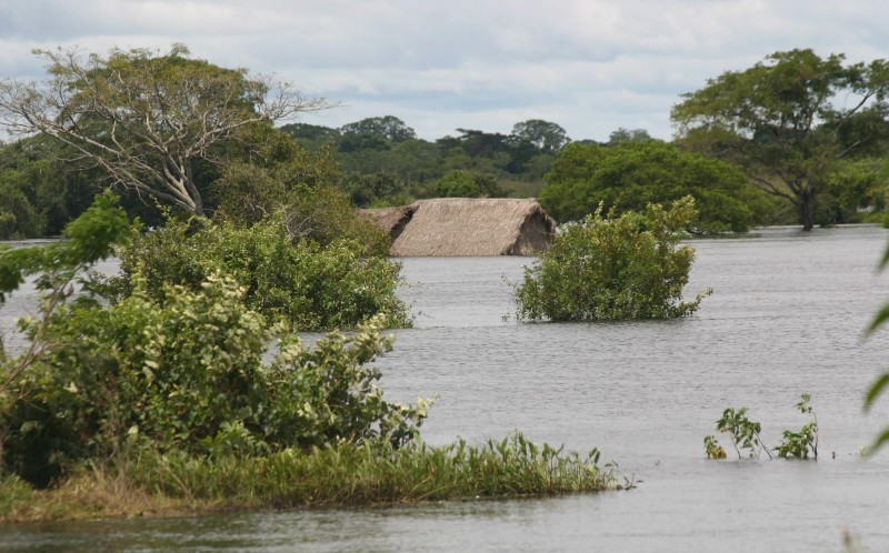 The roof of a house just visible above flood water el-niño