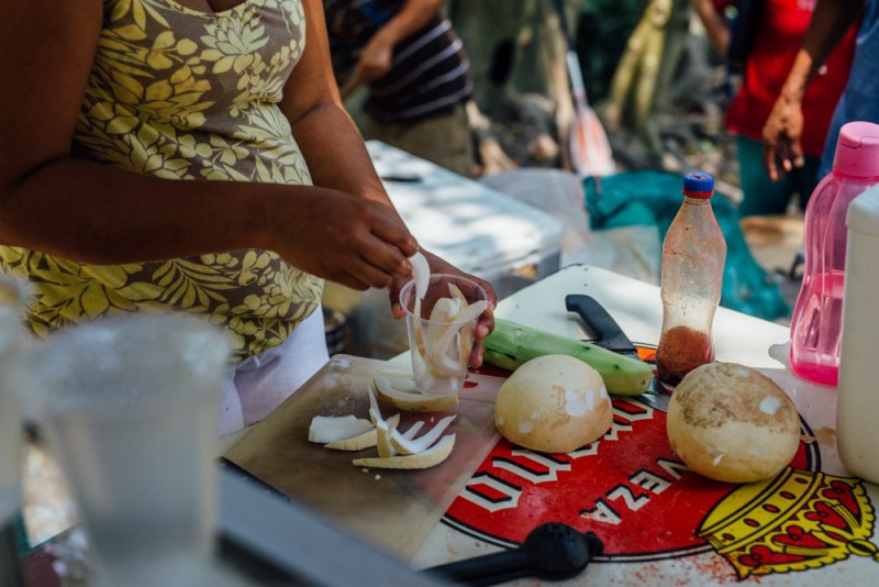 A woman preparing fresh coconut