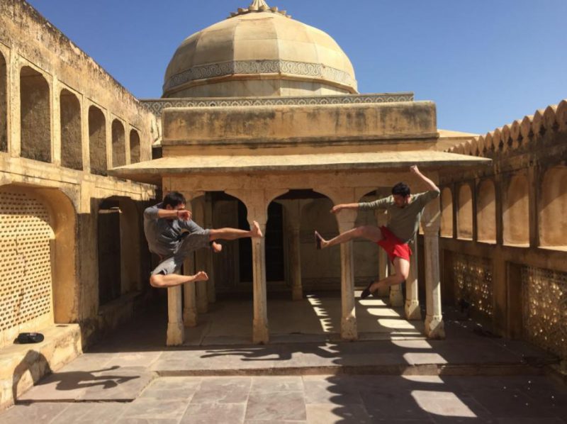 Making friends while traveling: Two friends doing a fun, silly ninja pose together