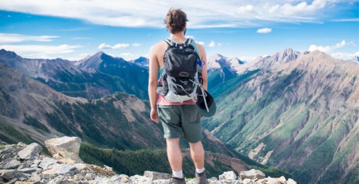 Backpacker wearing a backpack on a mountain