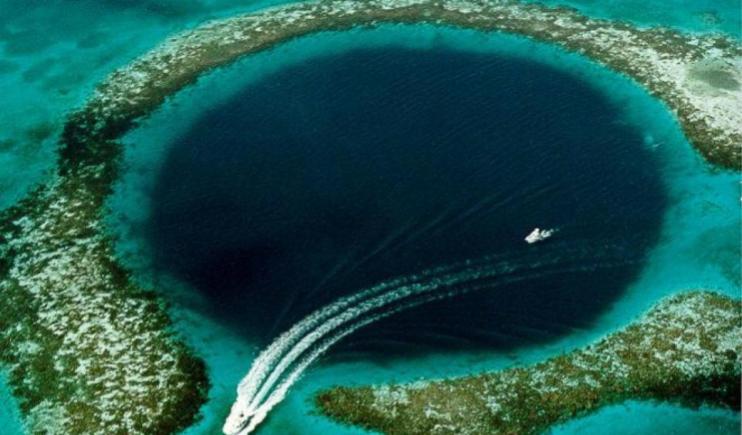 A stunning ariel view of the big blue hole in Belize- Best Scuba Diving Spots 