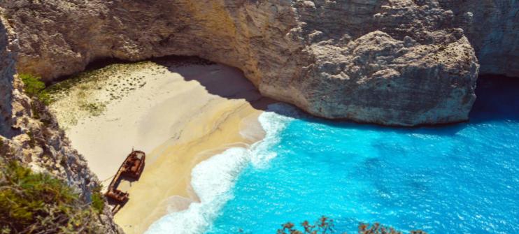 An aerial view of the beautiful Navagio Beach, an underrated beach in Europe 