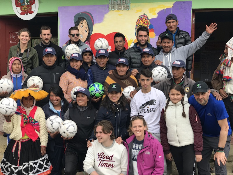 A group of locals and futbol for kids volunteers in Peru