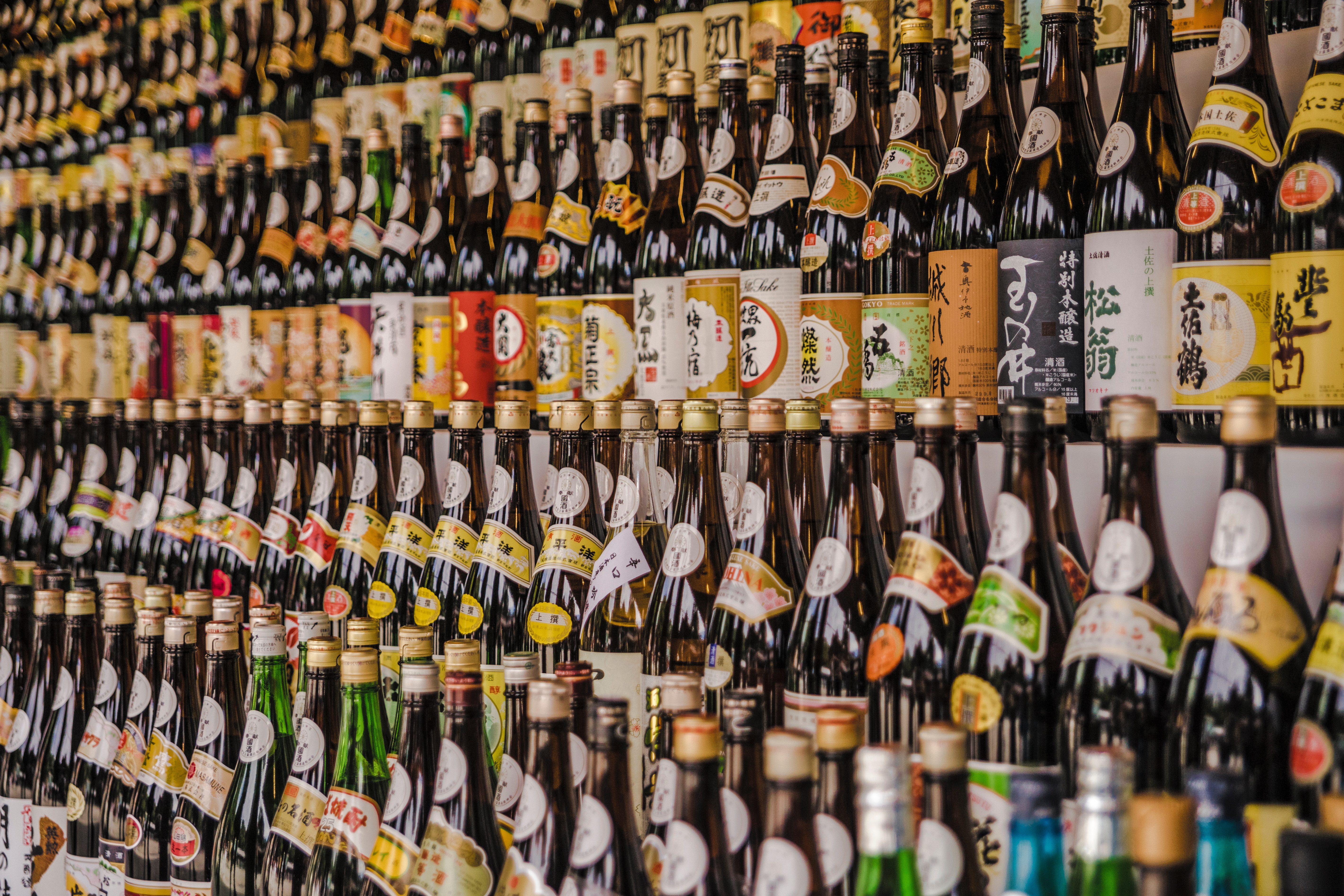 A shop wall lined with a variety of alcohol bottles