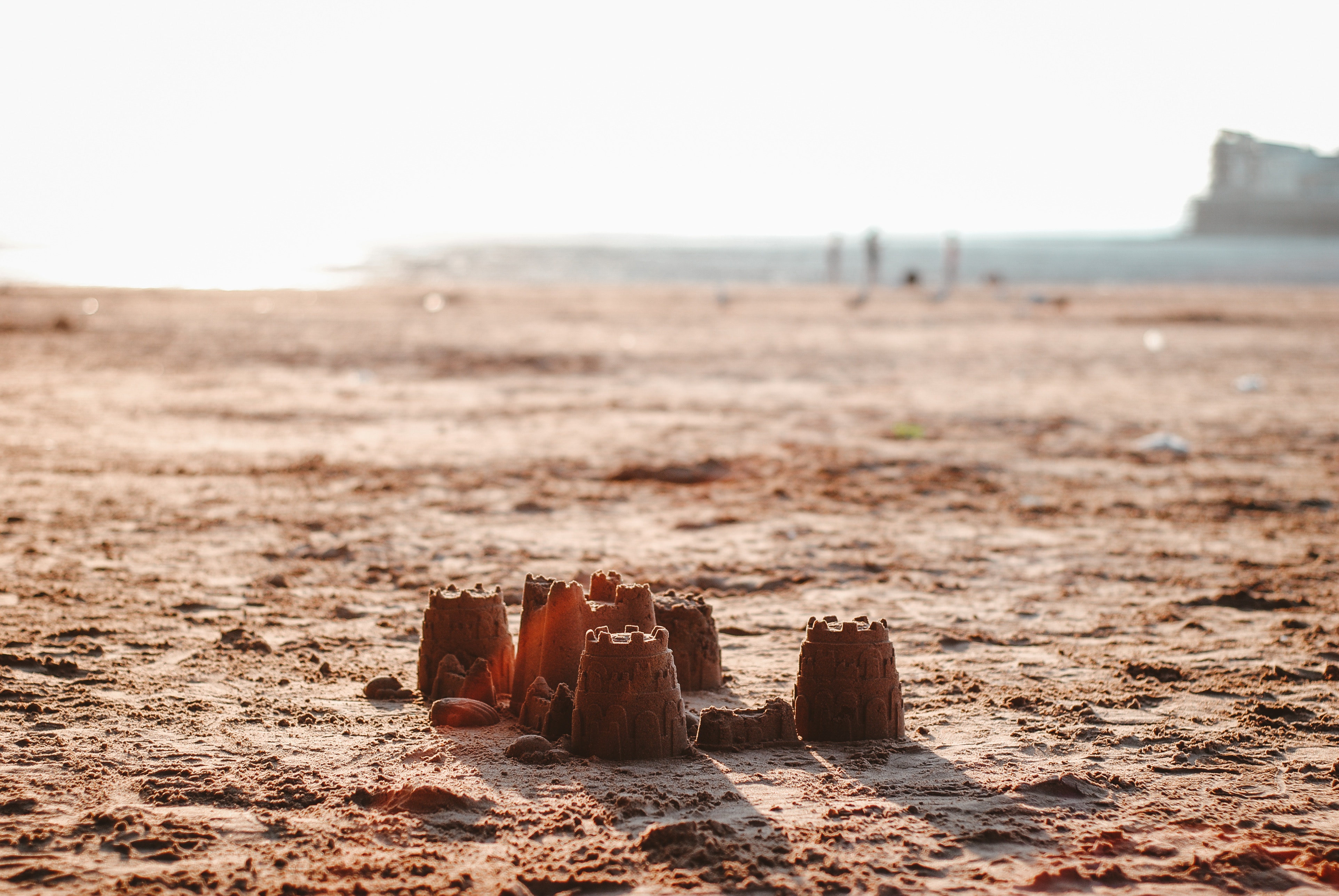A lone sand castle on a beach
