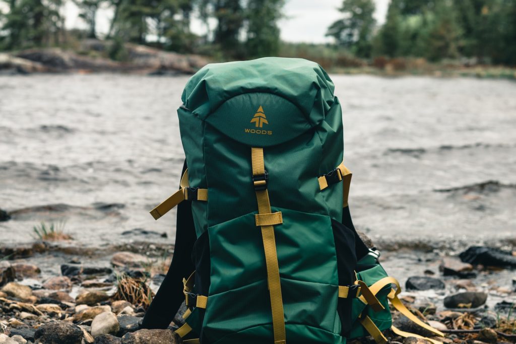 green hiking bag woods