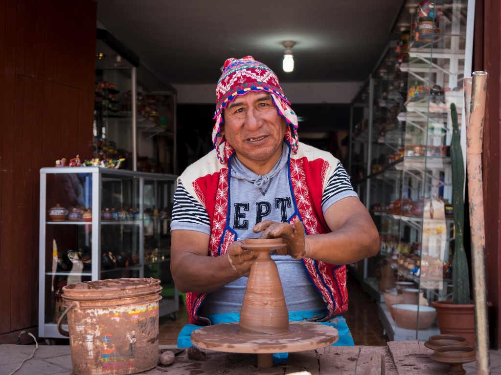 man making pottery in peru