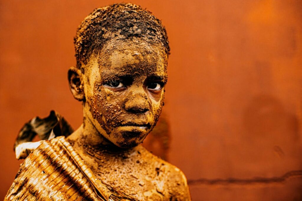 a child covered in mud