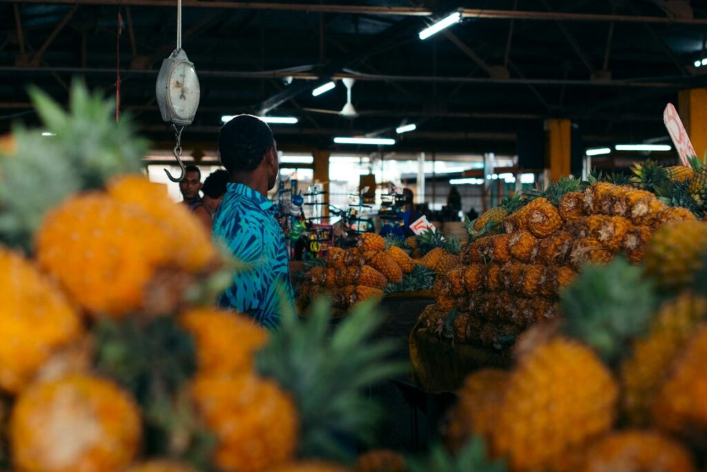guy buying pineapples in pineapple market in suva fiji