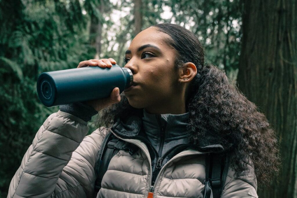 girl drinking from water container