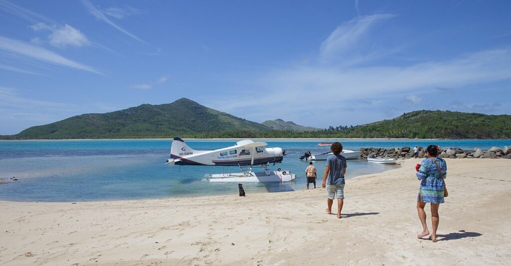 tourist riding an aircraft by the ocean in yasawa fiji