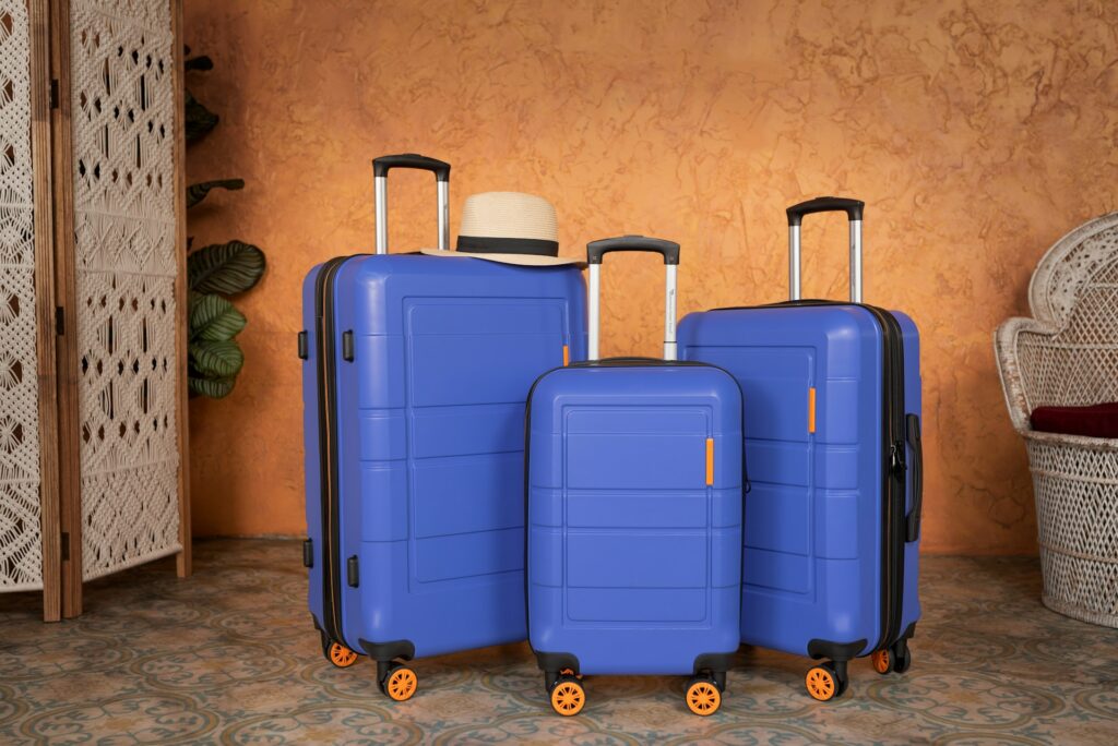 Three blue hardshell luggage